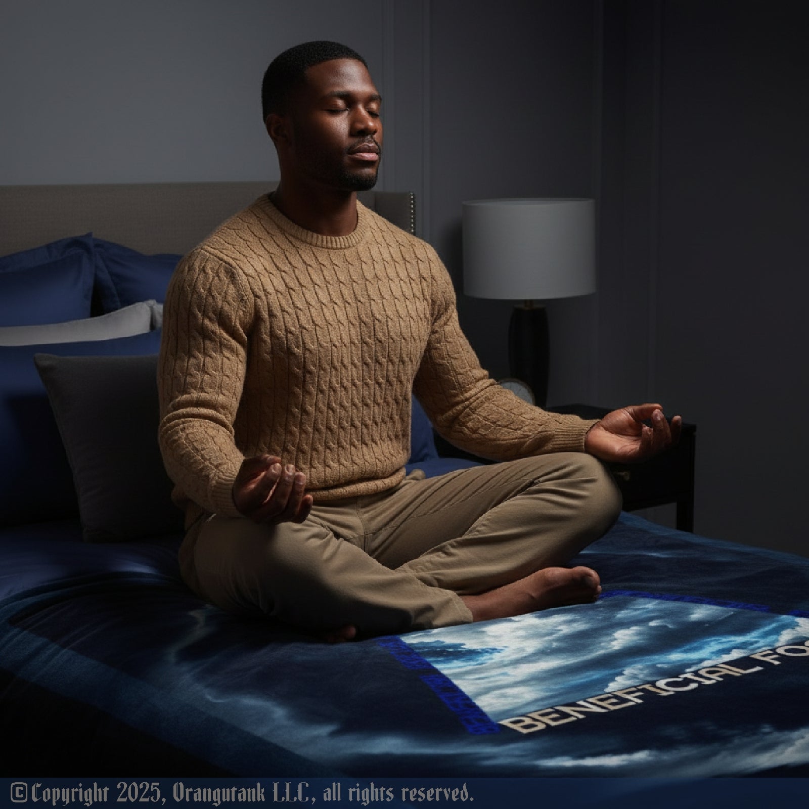 Man meditating on a bed with Beneficial Focus blanket and a dark background