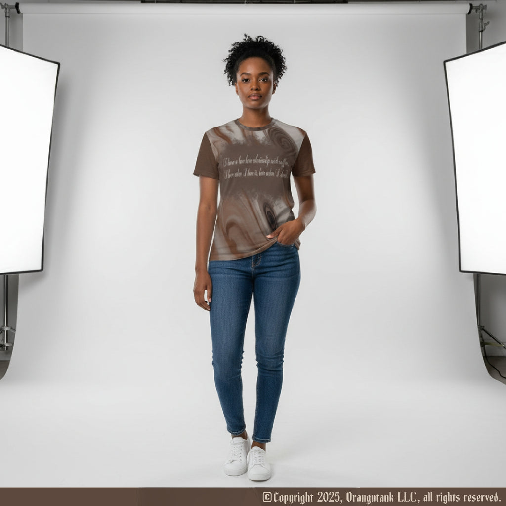 Person wearing a brown and beige coffee pattern shirt with blue jeans standing in a studio setting with lighting equipment.